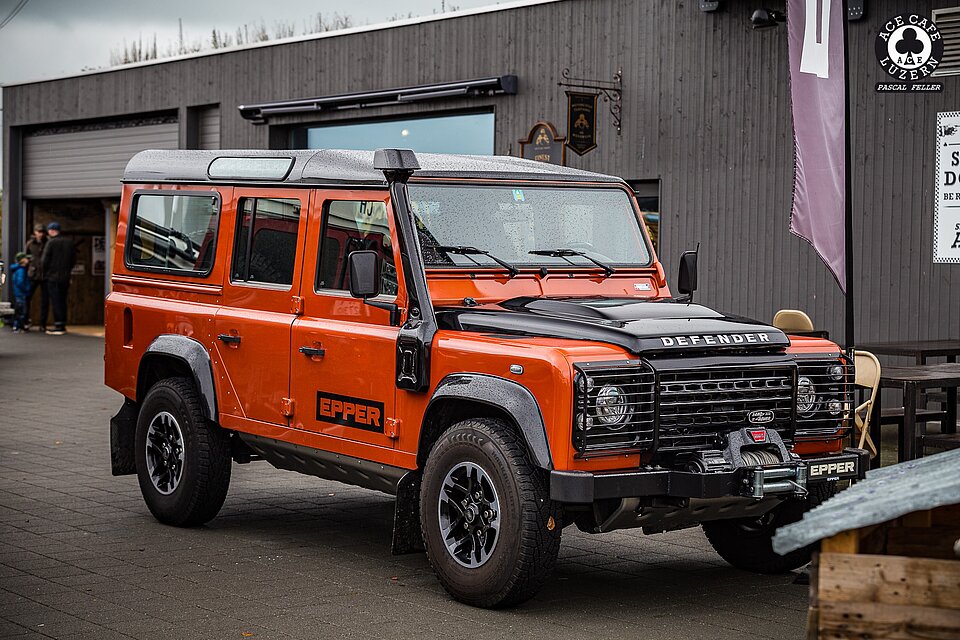 Ein orangener Land Rover Defender von der Garage EPPER